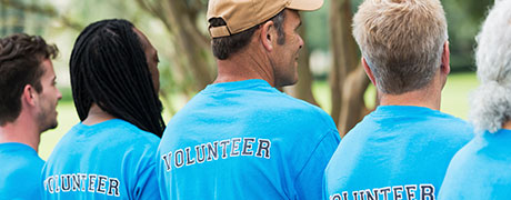 A group of volunteers gathering together for a charitable event outside