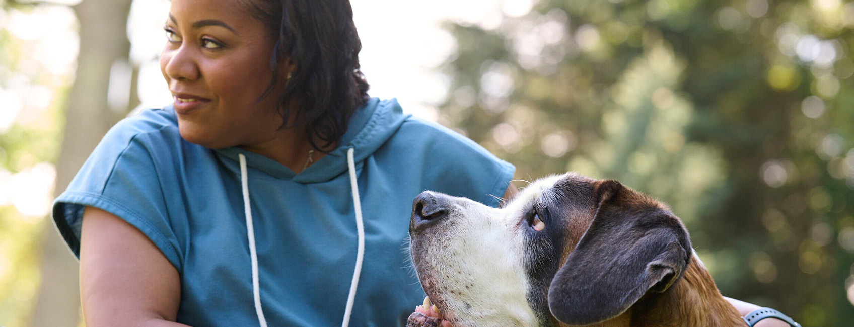 Two women sitting, a scientist working with a magnifying glass and a man standing next to a car 